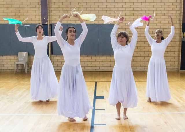 girls dancing with hands raised